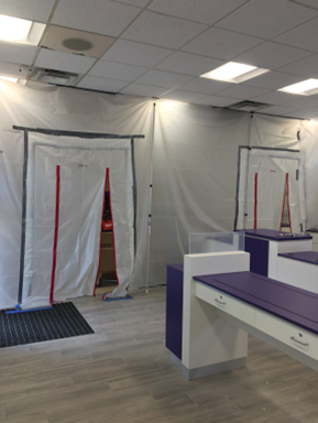 Existing retail establishment stayed in business during construction with temporay partitions installed 1